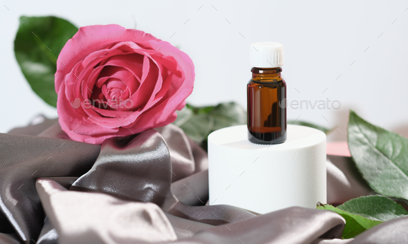 rose petals oil. essential oil for face care and skin moisturizing. a bottle of aroma oil