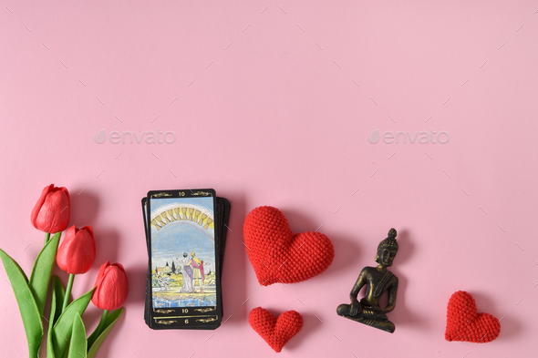 Tarot cards for love with hearts and tulips on a red background.