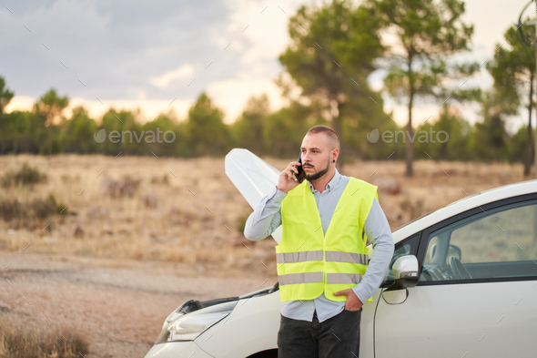 a man calling the automobile insurance company because he has had a breakdown in his car