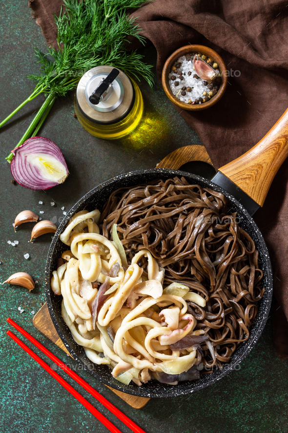 Spicy Noodles, Korean traditional food. Buckwheat soba noodles and squid with sour cream sauce