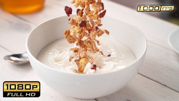 Granola Falling into Bowl with Milk alt