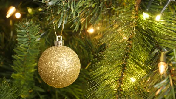 Golden round ornament close-up 4K 2160p 30fps UltraHD footage - Gold color bauble on the Christmas   alt