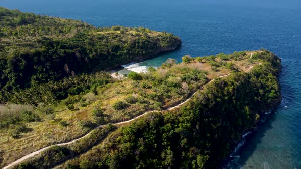 Fly Around Cliff and Rocks Over Ocean Along Coast alt