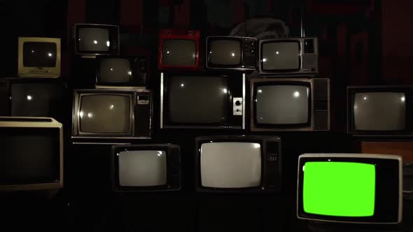 Old TV with Green Screen in a TV Wall. alt