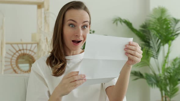 Happy Brunette Woman Reading Good News in Letter Bank Statement alt