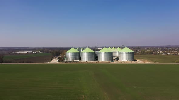 The Silver Silos on Agro Manufacturing Plant for Processing Drying Cleaning and Storage Products