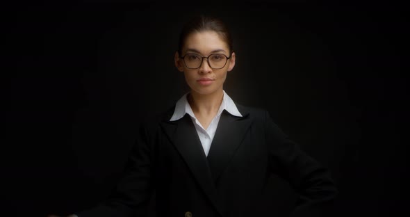 Strict Business Woman with Glasses Shows a Gesture Ok