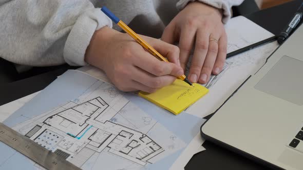Male Hands Drawing on the Plan with a Pencil and Rule on the Table alt
