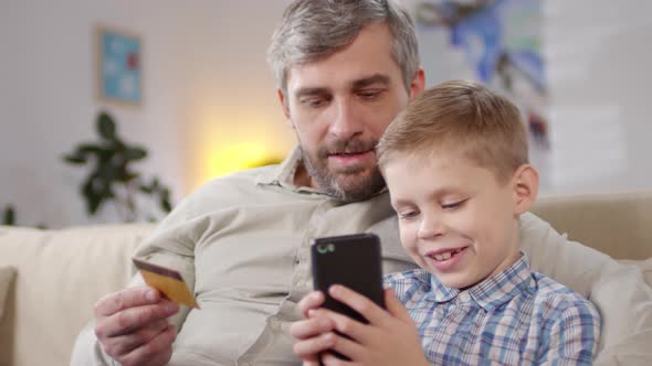Father and Little Son Shopping Online alt