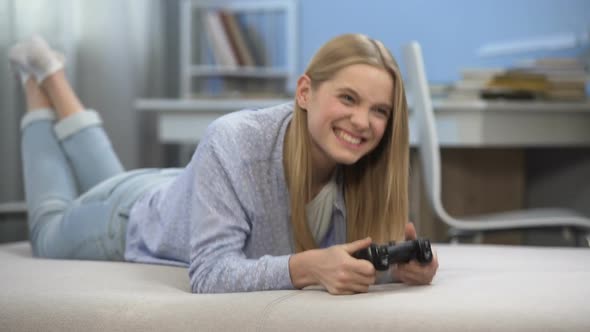 Emotional Teenage Girl Playing Video Game Using Joystick, Youth Entertainment alt