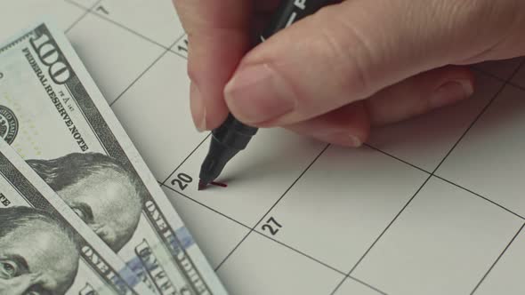 Marking Tax Day Date on a Calendar with Red Marker alt