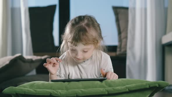 Small Child Hold Pad Computer Surfing Internet Play Game At Home Alone. alt