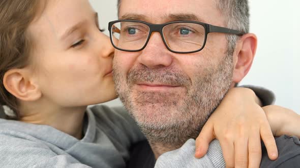 Family Portrait of Senior Father and Little Blond Daughters are Hugging Indoors and Smiling Fathers alt