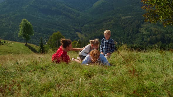 Family Lying Ground Green Meadow on Summer Vacation alt