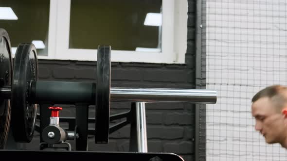 Fit Man Set Weight for Training Barbells in Gym alt