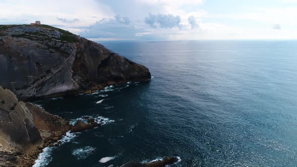 Waves of the Atlantic Ocean crash on coastal rocks alt