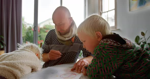 Father helping his children in drawing at home 4k alt