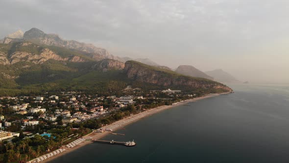Aerial Drone Shot of Kemer Coastline with Turquoise Water and Numerous Hotels at Sunset