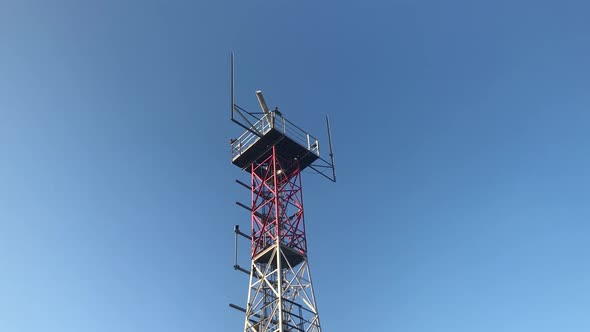 Red Radio Beacon Against Blue Sky