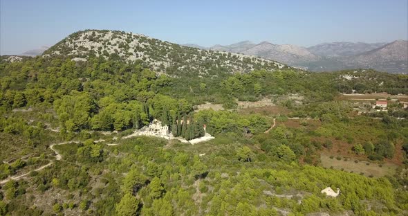 Church hidden in hills of Dubrovnik, Croatia. Aerial shot over beautiful Croatian hills on a sunny d alt