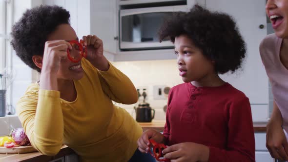 Mixed race lesbian couple and daughter preparing food in kitchen, Stock ...