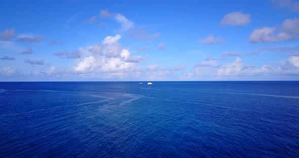 Wide aerial tourism shot of a white sandy paradise beach and blue sea background in colourful alt