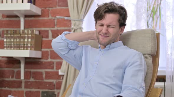 Tired Young Male Having Neck Pain in Modern Office alt