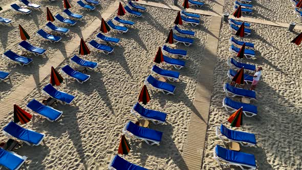 Empty sun loungers on the beach aerial view 4 K Turkey Alanya alt