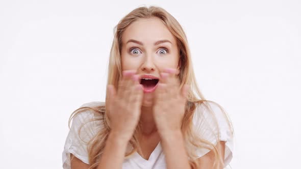 Young Beautiful Caucasian Blonde Girl Suprisingly Smiling on White Background in alt