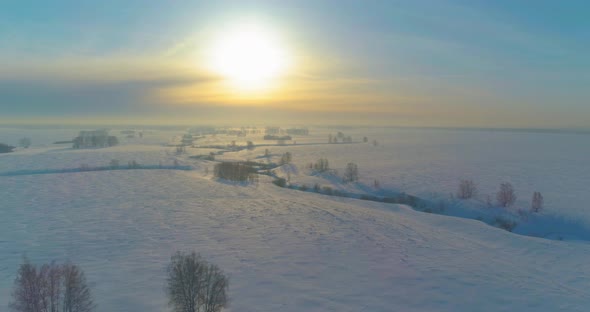 Aerial View of Cold Winter Landscape Arctic Field Trees Covered with Frost Snow Ice River and Sun alt