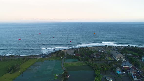 Kites Fly on the Ocean Shore Near the Rice Terraces in the Evening alt