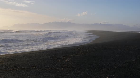 Iceland Beautiful Black Sand Beach Ocean Shoreline On Sunny Day