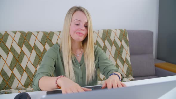 Professional freelancer woman working on notebook pc in living room during lockdown alt