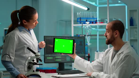 Scientists Using Tablet with Green Chroma Key Screen Talking alt