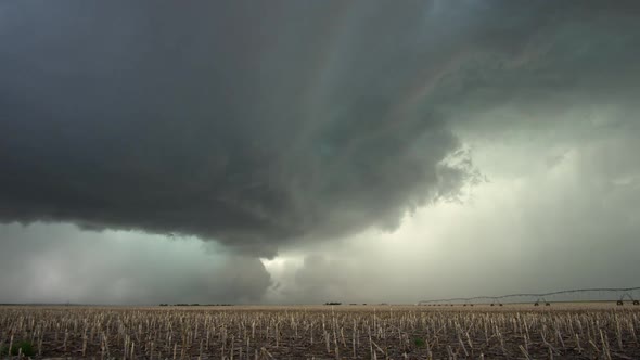 Severe thunderstorm moving through farmland in Nebraska as lightning flashes alt