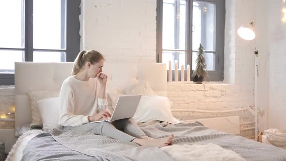 Coughing Sick Young Girl Working on Laptop Sitting in Bed alt