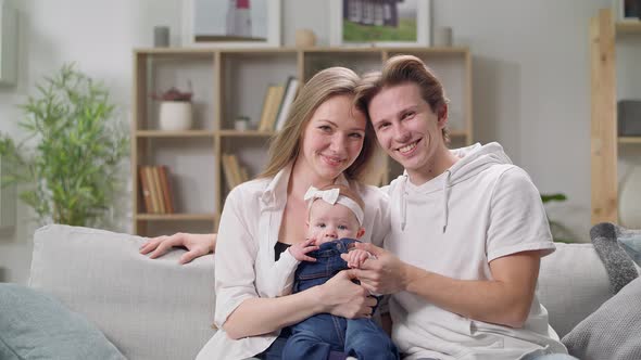 Young Family on the Couch in the Living Room alt