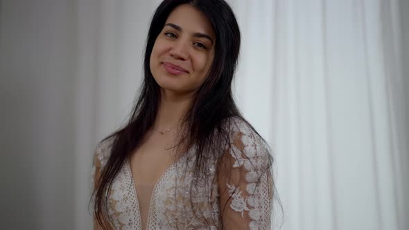 Portrait of Proud Happy Middle Eastern Bride in Luxurious Wedding Dress Posing Indoors in the alt