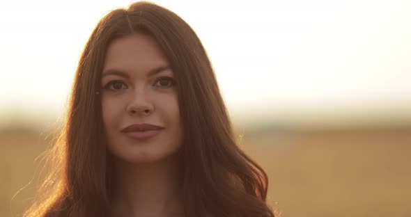 Beautiful Woman Smiling at Camera Outdoors.