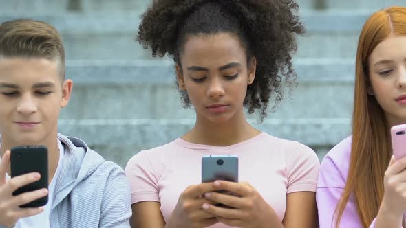 Caucasian and Mixed Race Teens Scrolling Smartphones, Gadget Addiction Concept alt