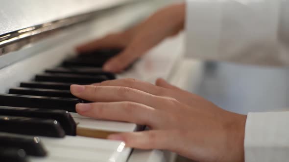 Extreme Closeup Hands of Unrecognizable Female Musician Performer Playing on Classical Piano at Home alt