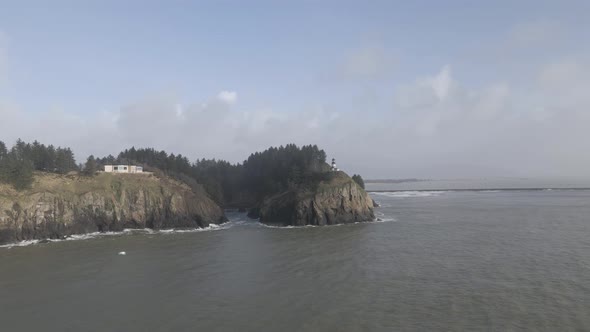 Cape Disappointment, white misty clouds, turbulent ocean waves, aerial alt