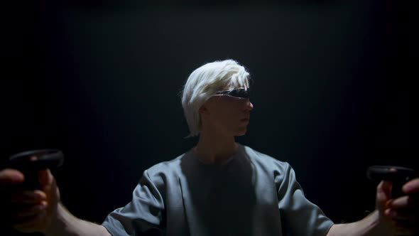 Guy Playing Vr Game in Futuristic Glasses Dark Room alt