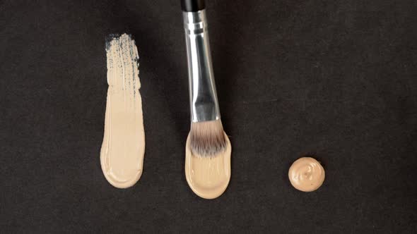 Smearing Foundation Tone on Black Background alt