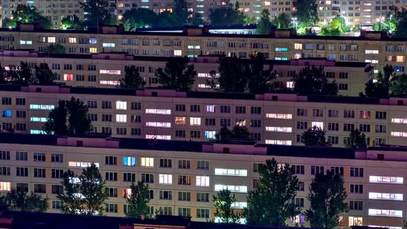 Timelapse of Residential Quarters of the Night City with the Lights on From the Windows of the alt