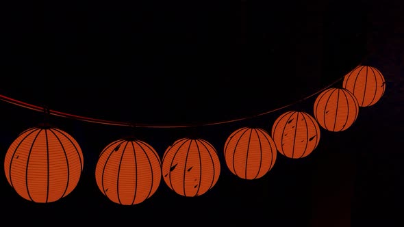 Halloween pumpkin garland hanging isolated on a black background alt
