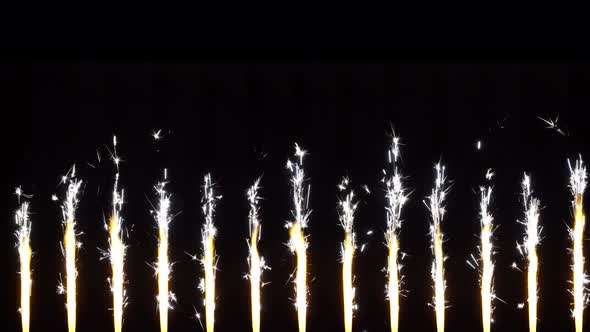 Burning bengal fountains candles on black background. 