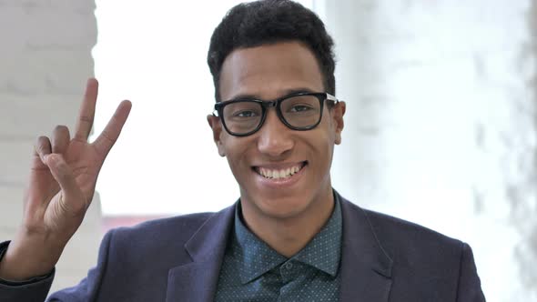 Victory Sign By Positive African Businessman alt