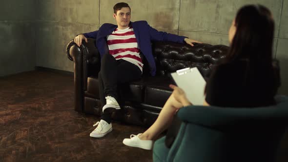 Man at the Reception of a Psychologist Talks About Their Problems alt