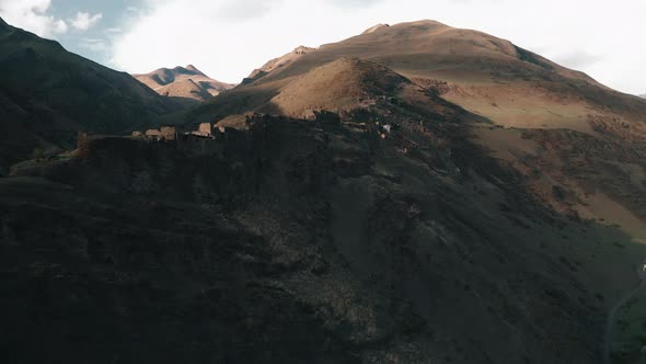 Rural landscape with abandoned village on mountain range, aerial view of destroyed buildings